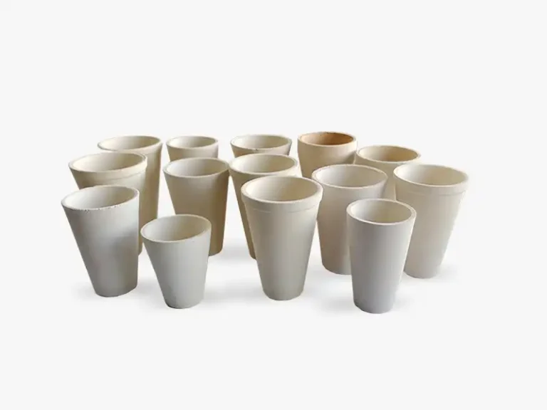 A collection of DECENT fire assay clay crucibles of different sizes, arranged on a white background.