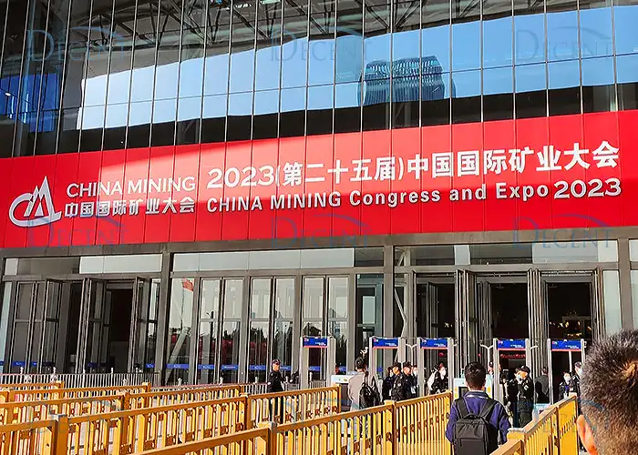 Entrance to the China Mining 2023 Congress and Expo, with a large red banner and attendees entering the event.