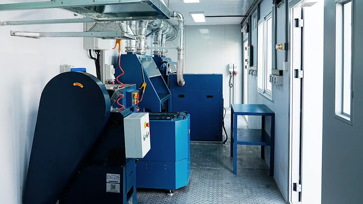 Australia Mobile Container Laboratory Project 2025 2 Interior of a DECENT Australia Mobile Container Laboratory Project 2025 sample preparation lab, showing blue industrial crushing and pulverizing equipment with extensive ventilation systems.