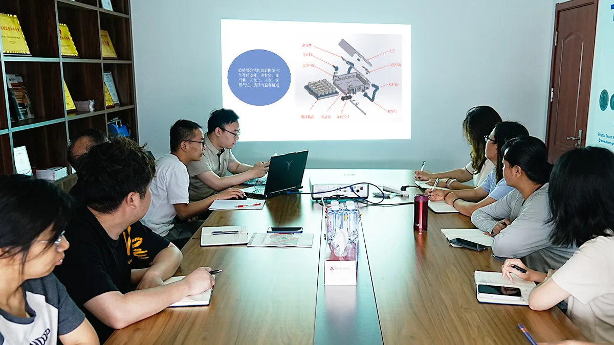 Qingdao Decent Group Successfully Held Internal Training On Crucible Tumbler Products插图2 A group of professionals in a conference room attending a product training session for the Qingdao Decent Group Crucible Tumbler, with a technical diagram on the projector screen.