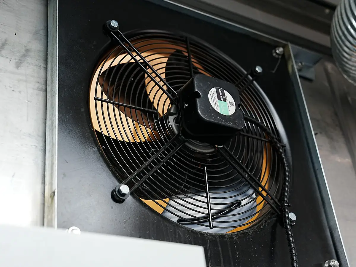 2025 Container Laboratory Triumph: DECENT Mexican Project Sets New Global Benchmark 6 Close-up of a black industrial ventilation fan with orange blades, labeled 'Axial Fan', installed in a DECENT container laboratory.