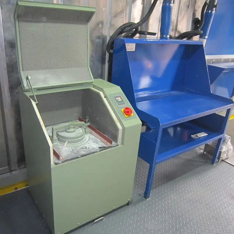 Revolutionary Container laboratory of sample preparation: 2015 South Korea Project 5 A pulverizer machine next to a blue metal workbench inside a lab container.