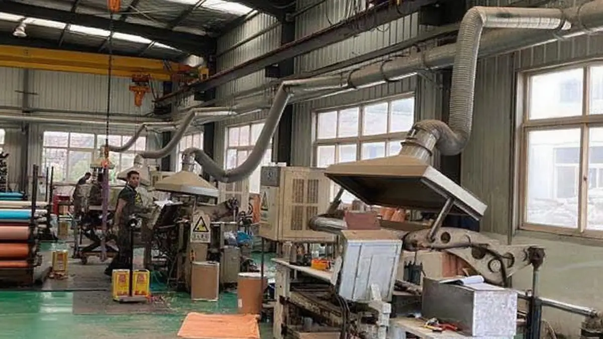 Factory Dedusting System Success Story in 2020 1 DECENT factory dedusting system with large ducts and hoods over machinery in an industrial setting