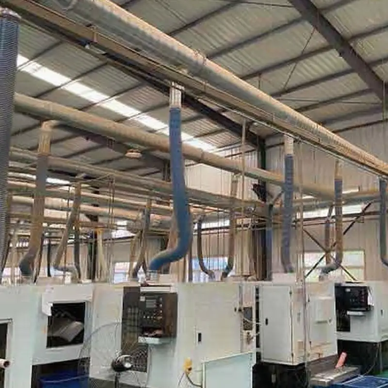 Factory Dedusting System Success Story in 2020 2 Factory interior with overhead dedusting system, blue ducts, and industrial machinery by Qingdao Decent Group