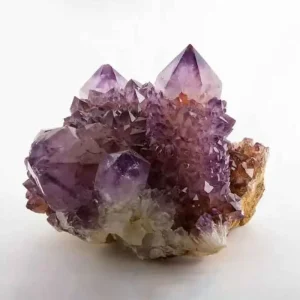 5 Stunning The Minerals Types That Will Amaze You - Nature's Hidden Treasures 17 A vibrant purple amethyst crystal geode cluster with varying shades of violet, growing on a light-colored matrix.