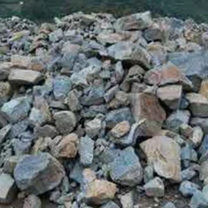 A large pile of gray and brown crushed rocks and stones used as construction aggregate.