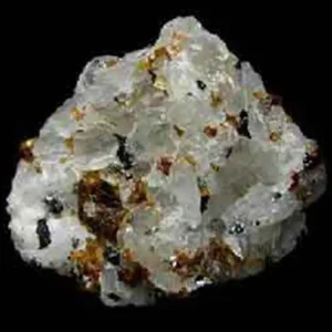 5 Stunning The Minerals Types That Will Amaze You - Nature's Hidden Treasures 31 A rough, crystalline specimen of translucent white cryolite, a mineral also known as 'ice stone', with dark reddish and black inclusions.