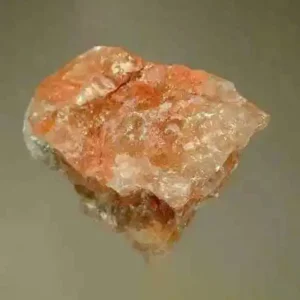 5 Stunning The Minerals Types That Will Amaze You - Nature's Hidden Treasures 30 A rough, translucent potash mineral specimen with a mottled pinkish-orange and white appearance, showing its crystalline structure.