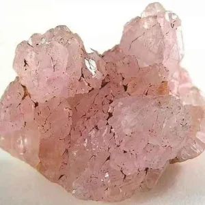5 Stunning The Minerals Types That Will Amaze You - Nature's Hidden Treasures 16 A close-up of a raw, pale pink rose quartz crystal cluster with a translucent and fractured texture.