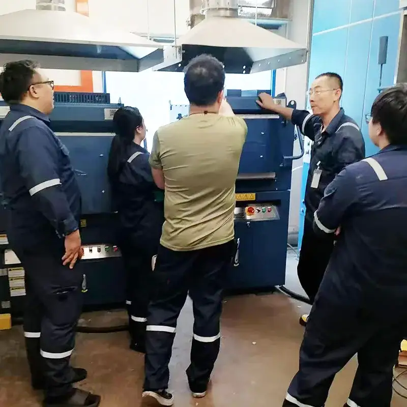 Qingdao Decent Group team training laboratory staff on DECENT fire assay furnaces in a Singapore lab.