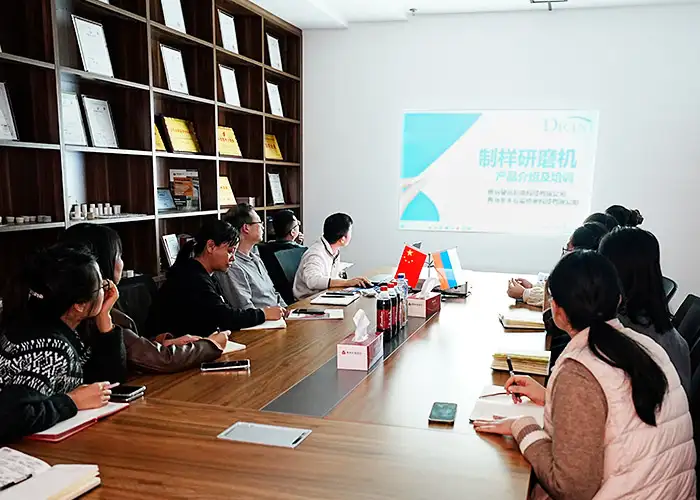 Qingdao Decent Group employees attending a DECENT Grinding Machine training session in a conference room.