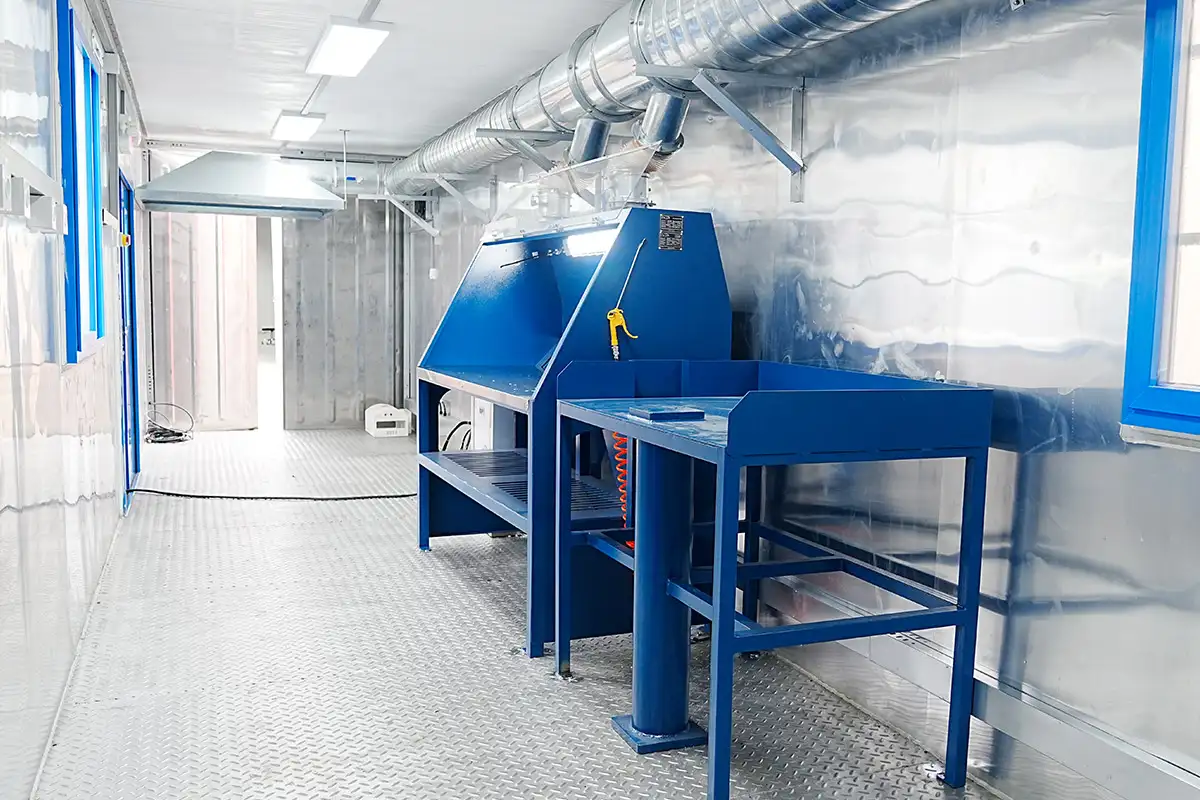 Modular Gold Assay Lab: Triumphant Delivery of All Four Units in Harsh Central Asia 5 Interior of DECENT's Modular Fire Assay Laboratory showing blue workbench, fume hood, and large ventilation ductwork.