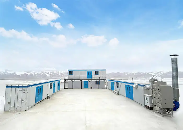 Modular Gold Assay Lab cluster by DECENT installed at a snowy, remote mining site in Kyrgyzstan, designed for accurate gold analysis in extreme cold.