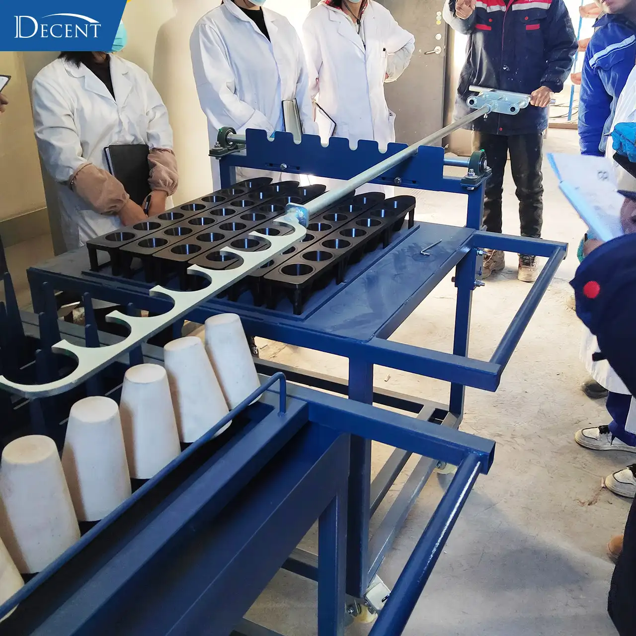 Qingdao Decent Group engineers providing on-site product training on crucible tilting fork operation to fire assay lab operators at Qinghai mining project in extreme cold prefabricated house.