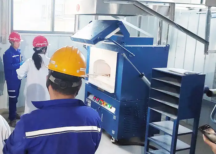 Qingdao Decent Group technicians guiding operators in hands-on practice of fire assay furnace operation at Qinghai mining fire assay laboratory under high-altitude fire assay lab construction.