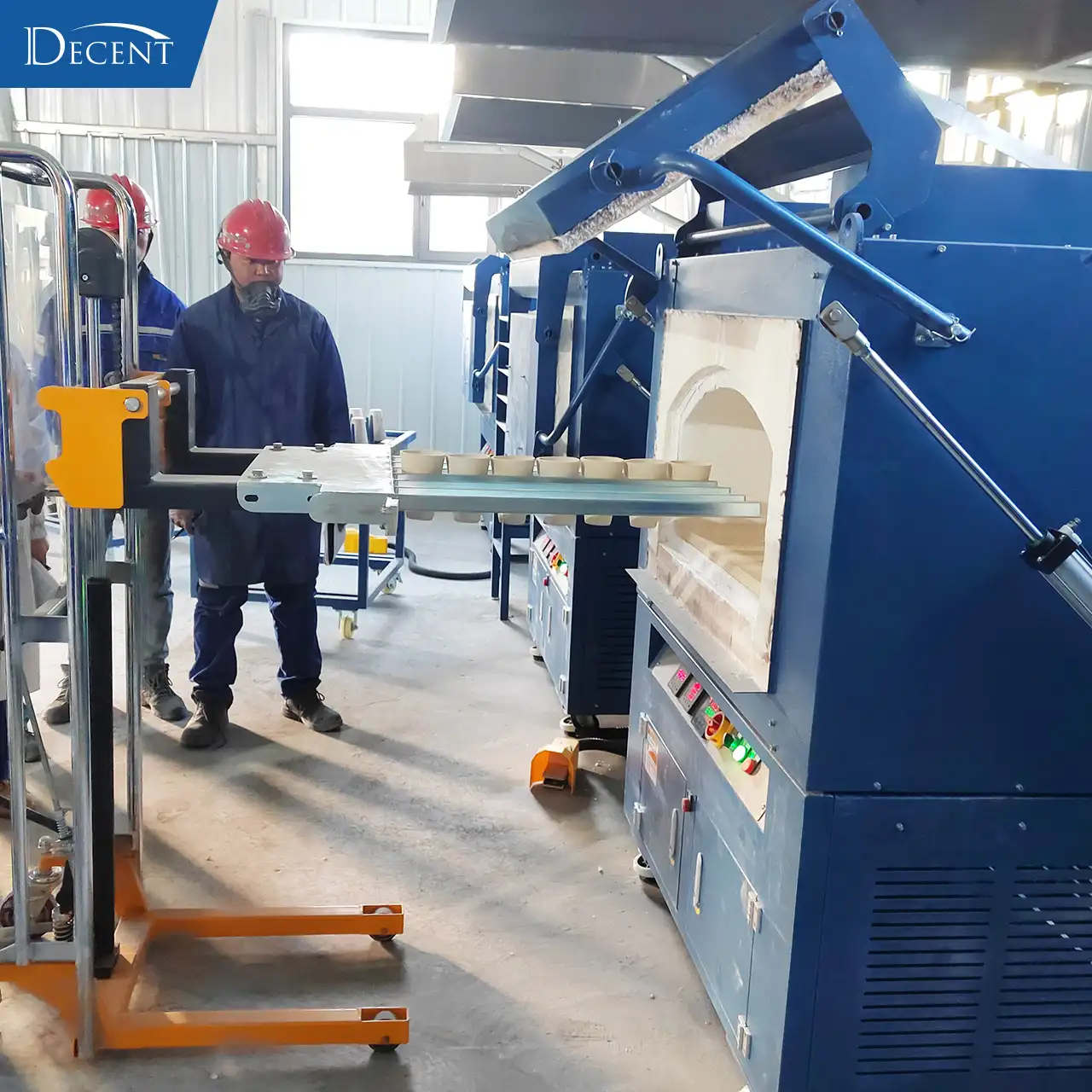 Qingdao Decent Group team demonstrating Manual Crucible Loader operation to client at Qinghai mining fire assay lab in extreme cold prefabricated house.