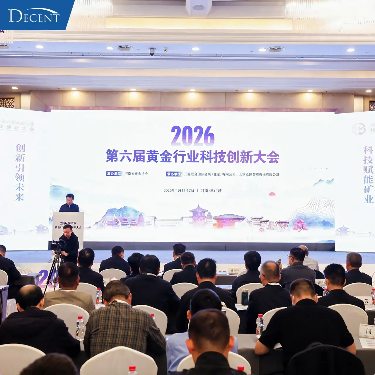 6th 2026 Gold Industry Tech Innovation Conference plenary session in Sanmenxia, Qingdao Decent Group showcasing fire assay automation systems for gold mining labs