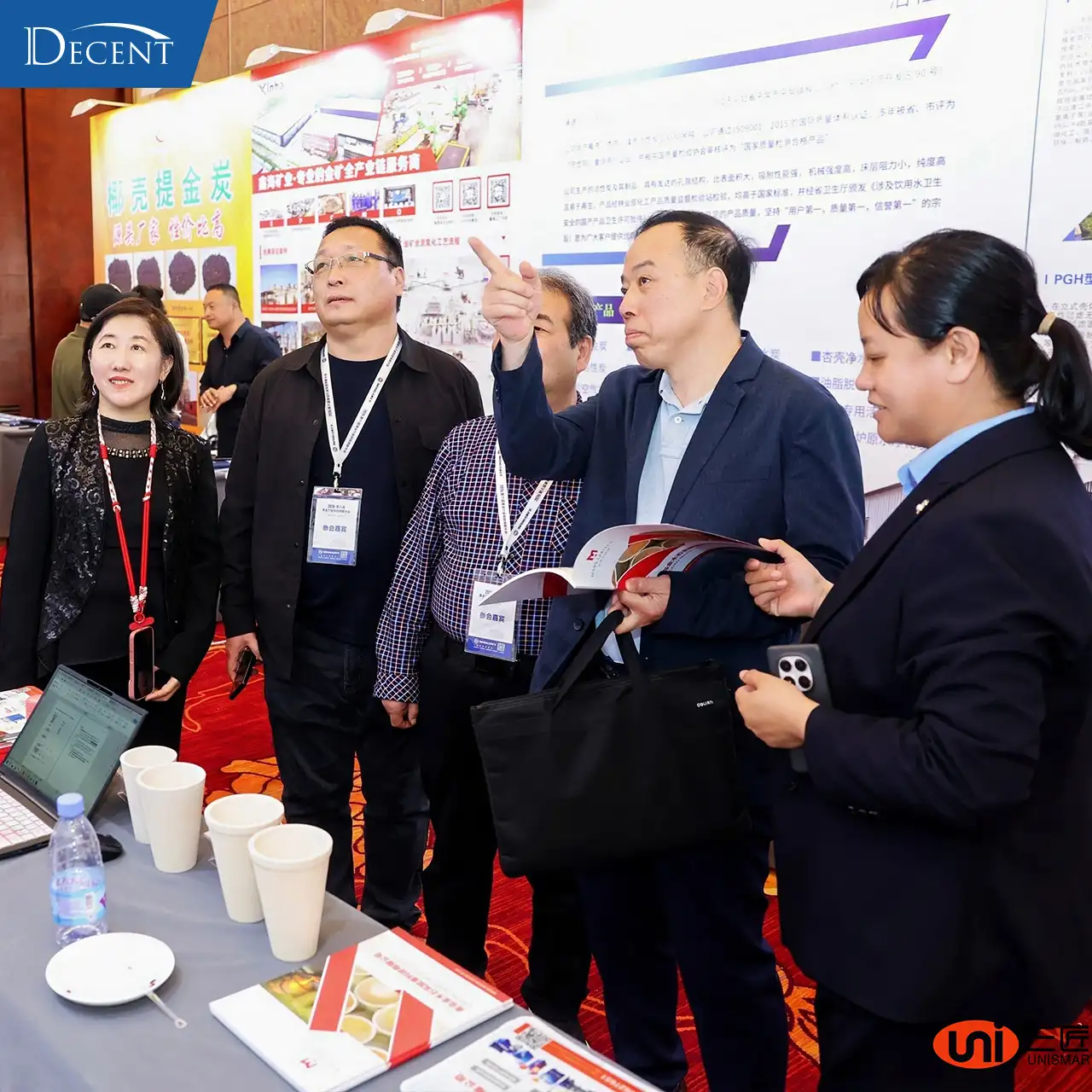 Industry leaders visiting Qingdao Decent Group booth at 2026 Gold Tech Conference, learning about fire assay automation and lab solutions for gold mining
