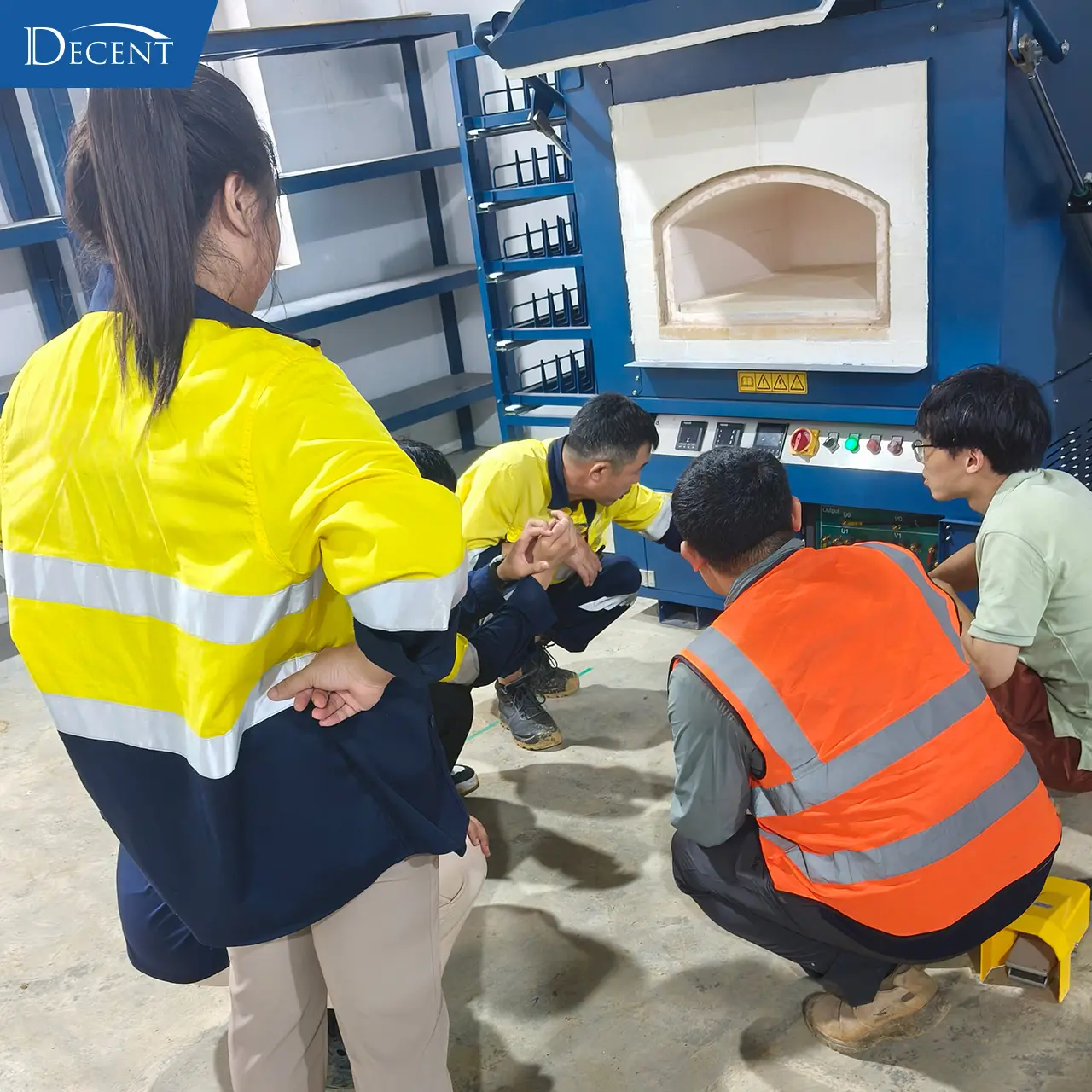 Qingdao Decent Group engineering team demonstrates fusion furnace operation for client staff at Laos fire‑assay lab for turnkey mineral laboratory construction